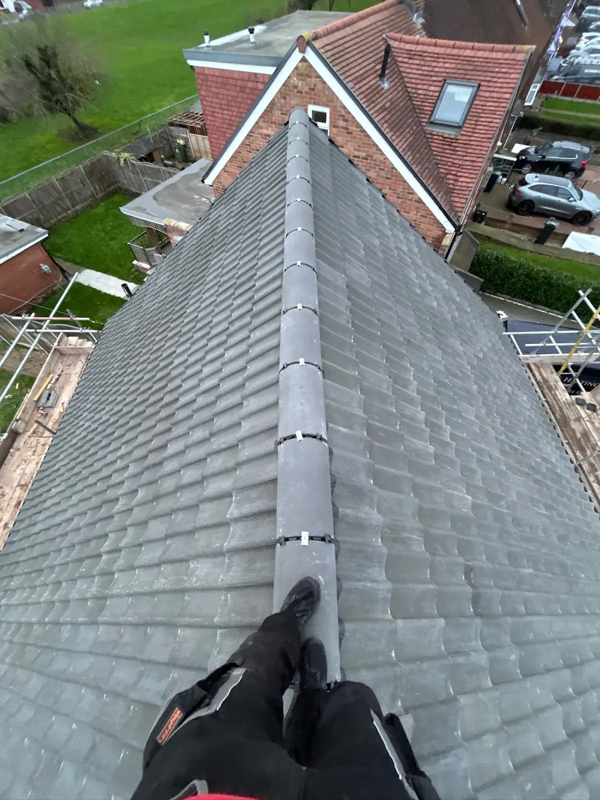 Grey tile roof with a dry ridge system by DJW Roofing & Leadwork