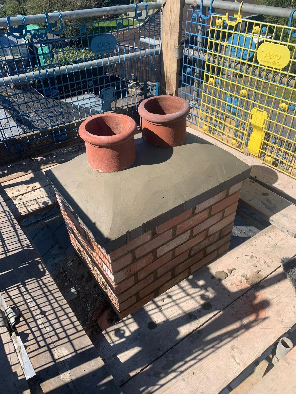Rebuilt chimney with new flaunching and clay pots by DJW Roofing & Leadwork